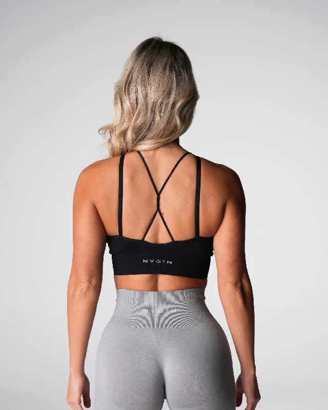 Compression tank sports bra – Combination of a tank top and sports bra, providing full coverage and support for the upper body.Black Strive Seamless Bra