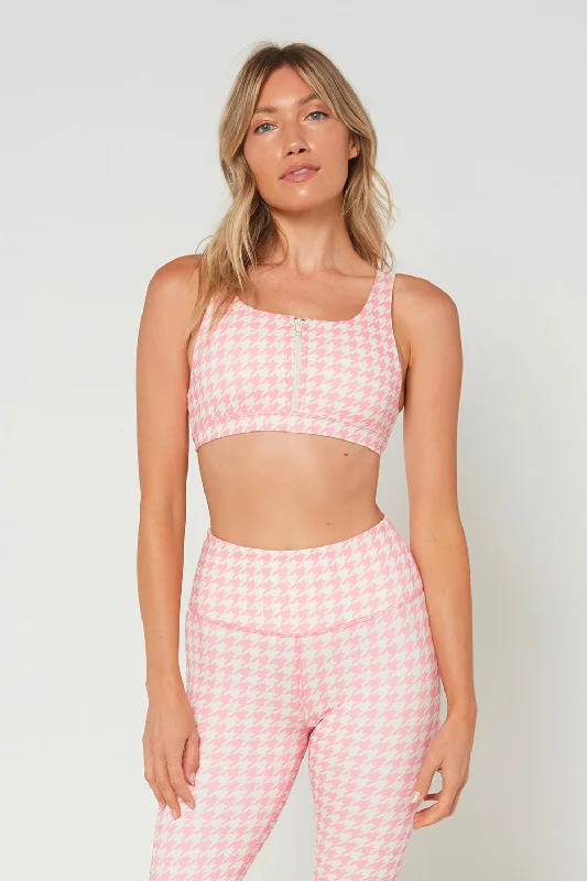 Compression sports bra – Sports bra that compresses the chest for a more secure fit and reduced bounce during high-impact activities.Think Pink Houndstooth Zip Bra