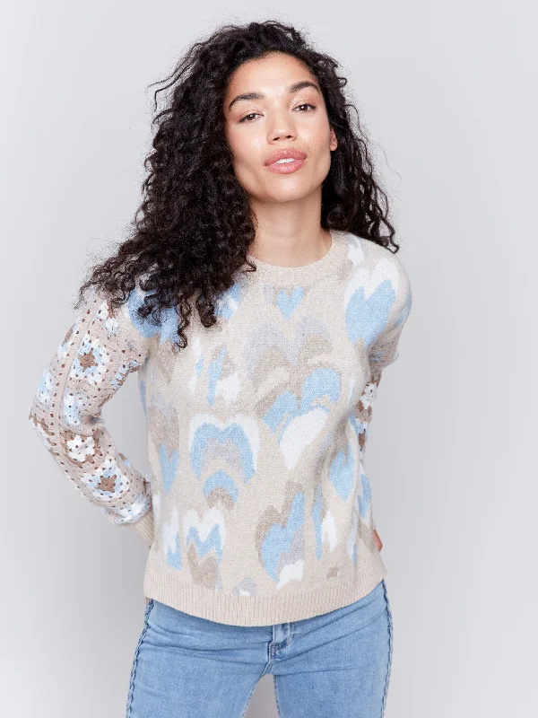 These keywords help define the specific style or feel of a sweater, allowing for more targeted searches or descriptions. Are you looking for a particular sweater style or just exploring different options?Jacquard Print Sweater with Crochet Sleeves - Ocean